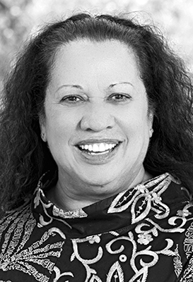 A close-up portrait of Emeritus Professor Colleen Hayward AM, Deputy chair who has her long, curly hair and is smiling widely