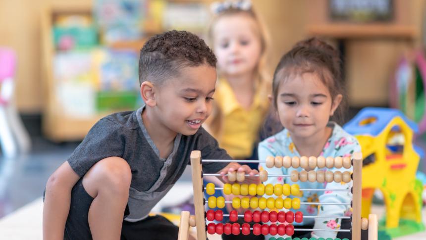 two children playing with abacus